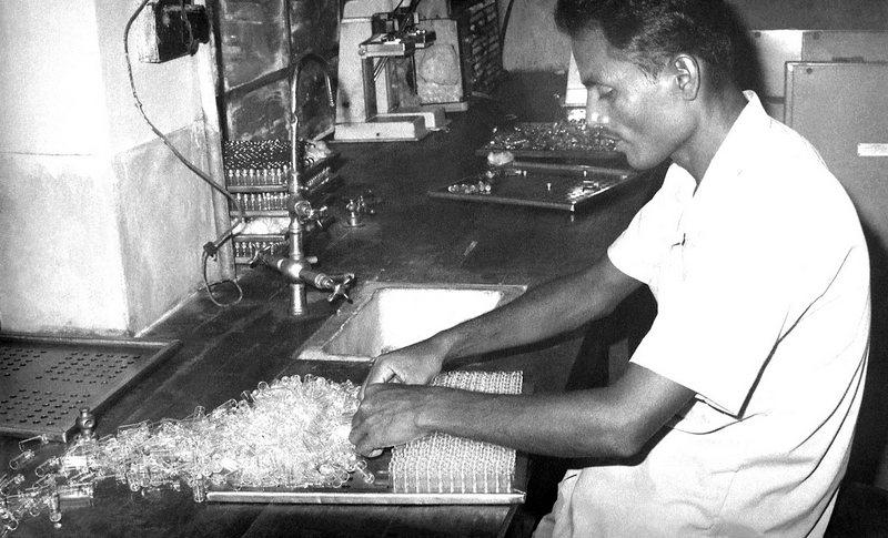 early 1970s Bangladesh. Arranging glass vials for shelf-drying