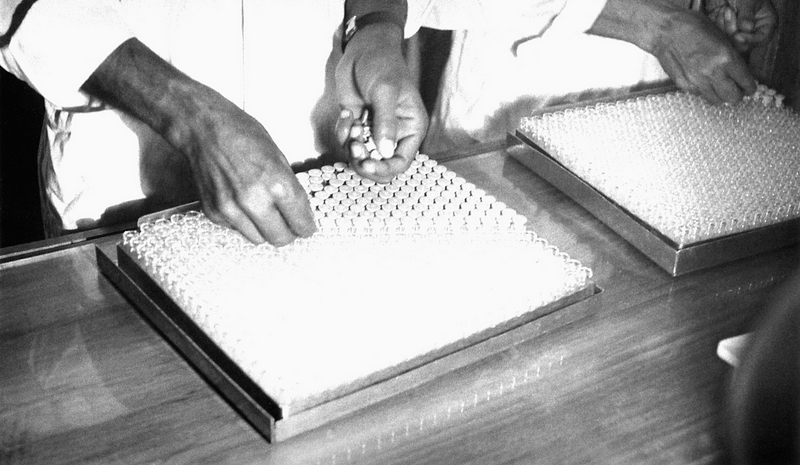 early 1970s Bangladesh. Inserting stoppers in vials