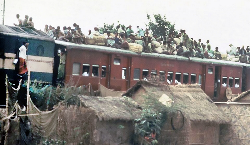 India. Crowded train and houses
